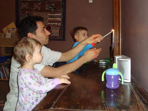 Hunter lighting Hanukkah candles -