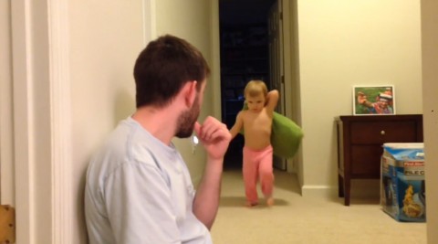 Daddy takes out toddler with pillow